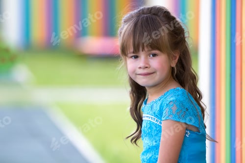 Preview: Portrait of little fashionable blond girl in blue dress, with gray eyes