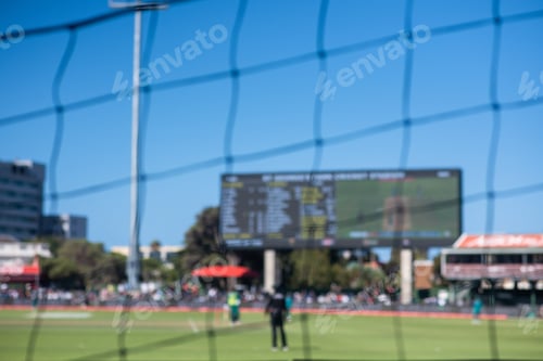 Preview: Close up shot of netting at cricket game seen from fan seating area