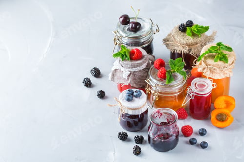 Preview: Assortment of seasonal berries and fruits jams in jars