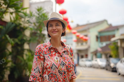Preview: woman exploring streets of George Town, during Chinese New Year.