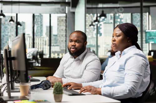 Preview: African american marketing team inspecting reports and data analytics