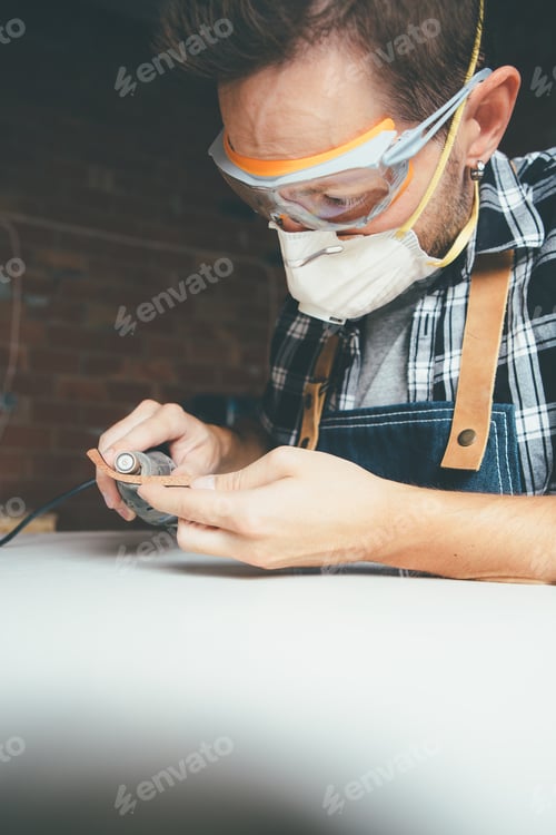 Preview: Man in eye protector at workshop