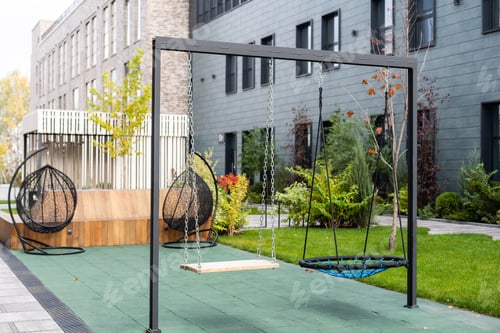 Preview: Empty swing on children playground,Children swing in the park,wooden swing, wooden swing on the lawn