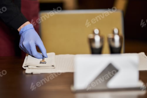 Preview: Table setting in cafe being done with wearing gloves