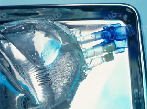Preview: Close up of sealed intravenous drip bag on a surgical tray