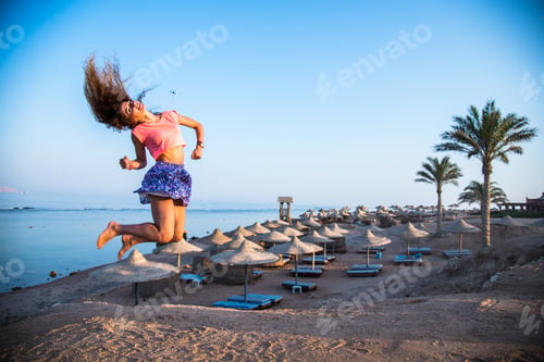 Preview: Girl Jumps High On The Sandy Beach Background