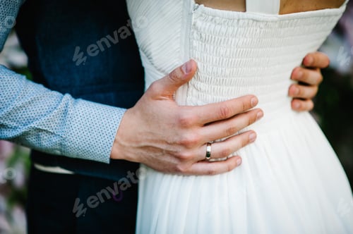 Preview: Newlyweds are hugging. Close up. The hands of bridegroom's husband embrace woman's. Wedding,