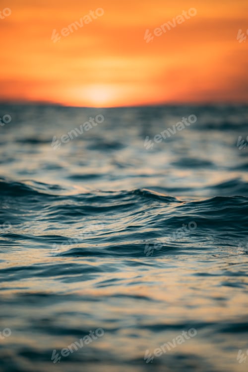 Preview: Ocean Water at Sunset With Orange Sky Above