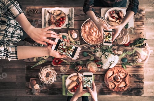 Preview: Group of friend take a picture with mobile phone before have lunch. top view.