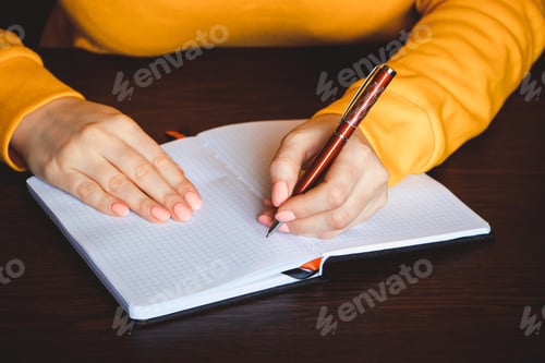 Preview: Businesswoman writing in notebook. Left-hander day. Concept of education