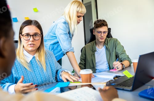 Preview: Diverse group of young business people working on new project together in office.