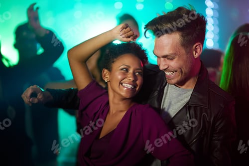 Preview: Shot of a smiling young couple dancing together in a night club