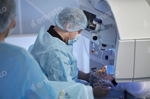 Preview: Man Performing Eye Surgery in Modern Operating Room