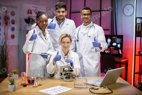 Preview: Portrait of a young team of multinational scientists, looking at the camera
