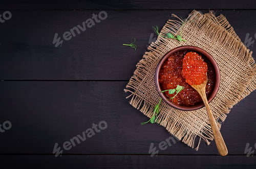 Preview: Salmon red caviar in bowl. Delicious food. Top view, overhead