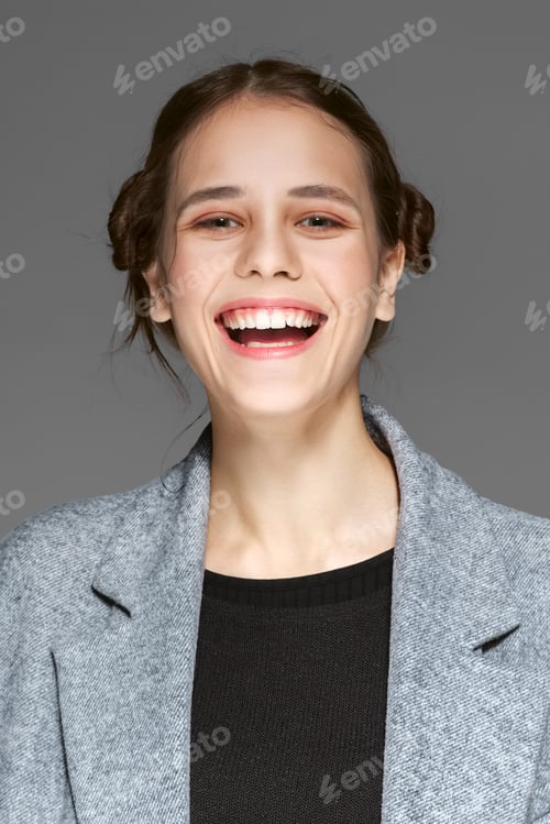 Preview: laughing young lady in gray warm coat