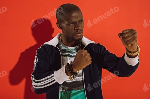 Preview: serious young african american man boxing in studio