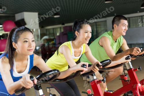 Preview: Group of young people spinning in the gym