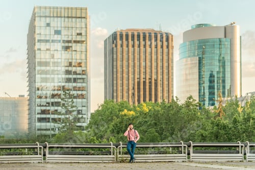 Preview: Man talking to his mobile phone from a viewpoint