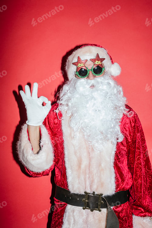 Preview: Man dressed as Santa Claus gesturing with funny glasses