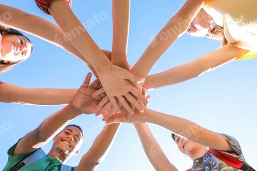 Preview: Group of children putting hands together outdoors. Summer camp