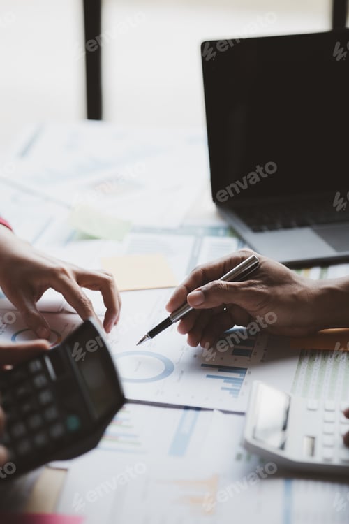 Preview: Business Professionals Reviewing Charts in the Workplace