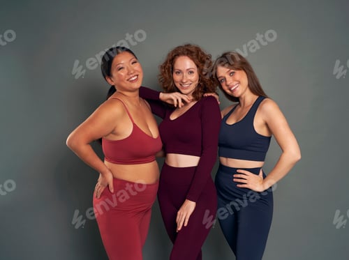 Preview: Portrait of of three young women in sports clothes in studio shot