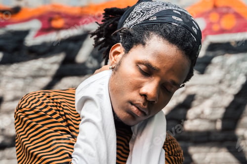 Preview: Portrait of young handsome stylish black man with natural hair afro dreadlocks. Afroamerican guy