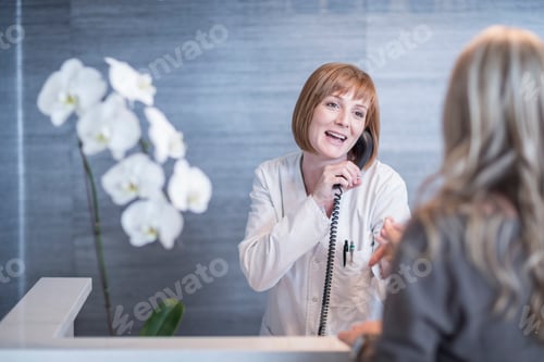 Preview: Receptionist greeting patient while on the phone