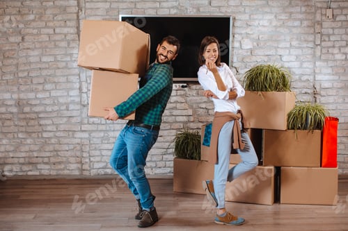 Preview: Young happy couple showing the keys of a new home