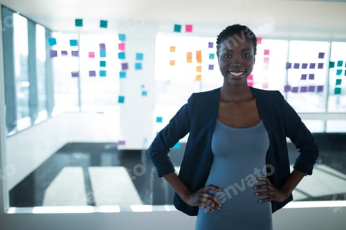 Preview: Confident businesswoman standing in modern office with colorful sticky notes