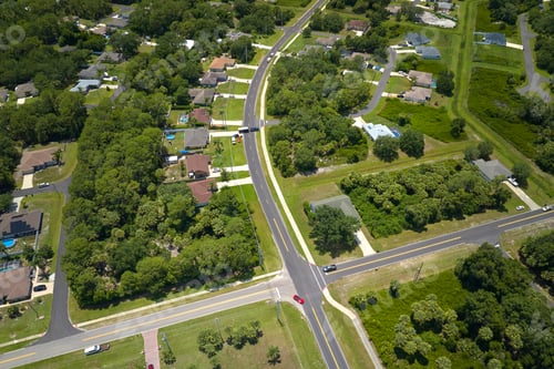 Preview: Aerial view of street traffic with driving cars in small town.