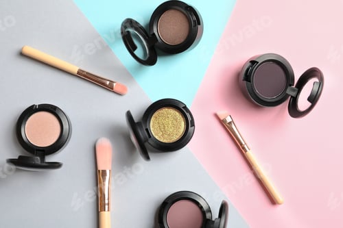 Preview: Flat lay composition with different eye shadows on color background