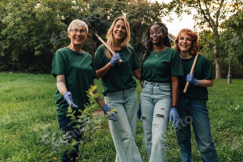 Preview: Four volunteers taking a break while planting trees in a park