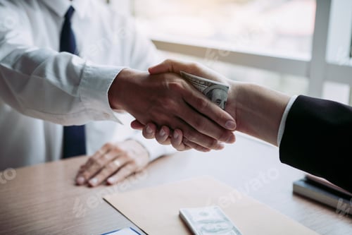 Preview: corporate businessmen shaking hands while one man places money on document