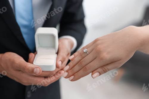 Preview: Making proposal. Woman with engagement ring and her fiance indoors, closeup