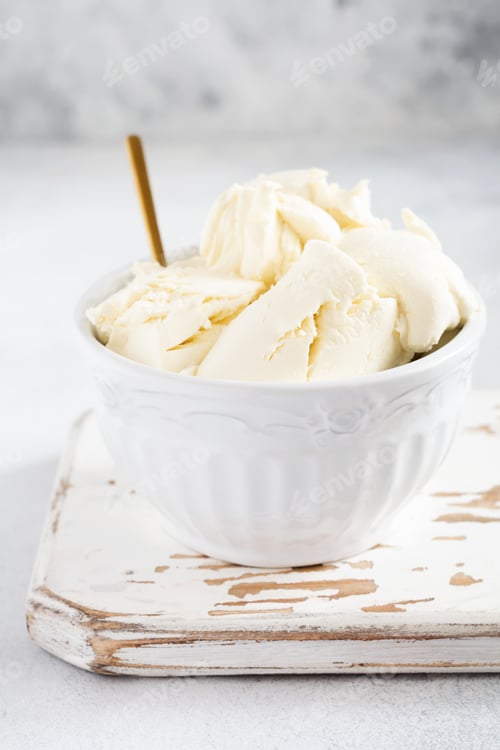 Preview: Fresh mascarpone cheese in a white bowl for making Italian tiramisu dessert on light background. Sel