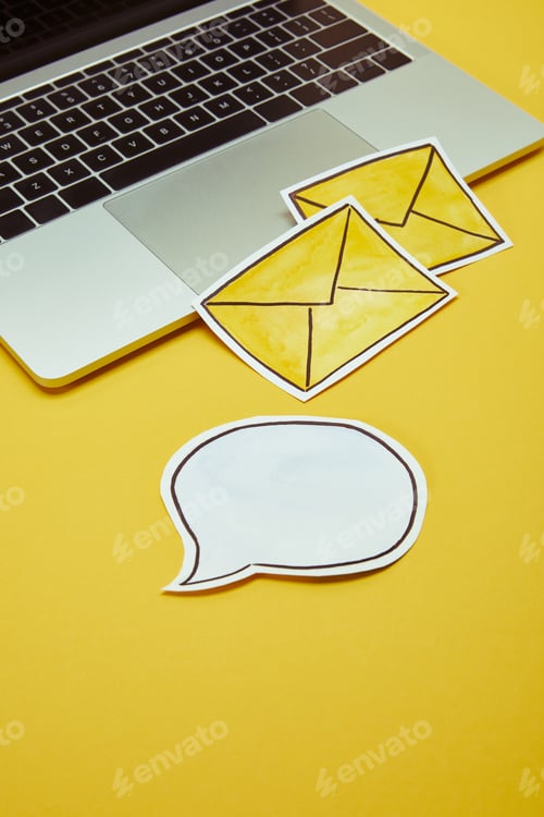 Preview: message signs, speech bubble and laptop on yellow surface