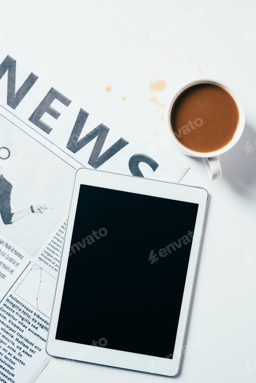 Preview: top view of tablet with coffee cup and newspaper on white surface