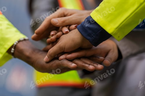 Preview: workers in high visibility safety gear and hard hats discuss operations