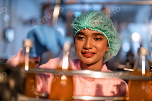 Preview: Beverage worker in drink factory stand working near drinking bottle conveyor production line