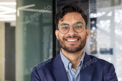 Preview: Confident young professional smiling in modern office environment