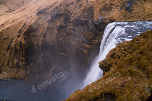 Preview: Skógafoss waterfall creating mist on icelandic landscape