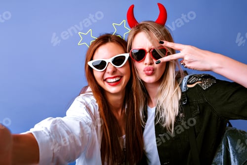 Preview: Young funny girls making selfie at studio making grimaces and going crazy