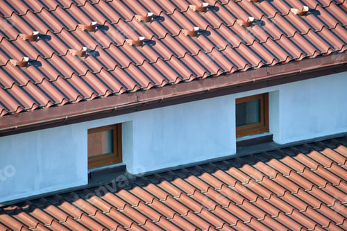 Preview: Closeup snow guard for safety in winter on house roof top covered with steel shingles. Tiled