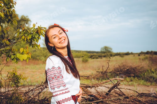Preview: Photo of a smiling young woman in ethnic ukrainian shirt