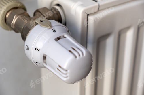 Preview: Closeup of heating radiator valve for comfortable temperature regulation on metal radiator