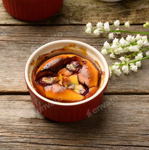 Preview: Cottage cheese dessert baked in portioned round ceramic plates on a wooden table