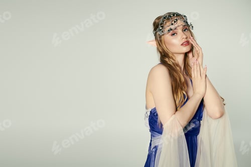 Preview: Enchanting elf princess: woman in blue dress with veil