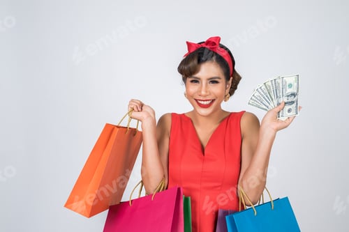Preview: Beautiful asian woman holding colored shopping bags